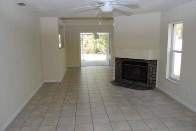 Tiled living room has fireplace