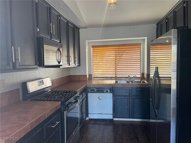 Kitchen featuring stainless steel appliances, tile