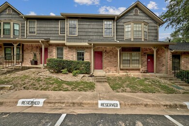 View of property with covered porch and brick sid