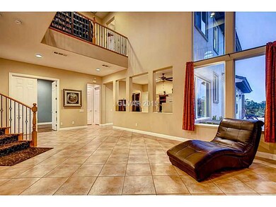 Living Room. HIgh ceiling & windows over look the