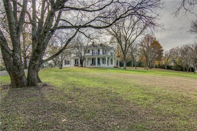 Breathtaking view of the front of the house displaying the gorgeous and very spacious  front yard .  