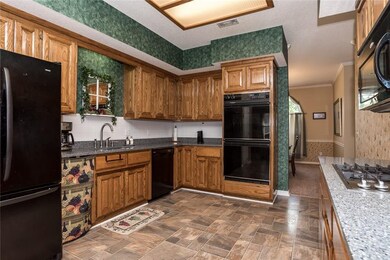 The kitchen has been updated with granite, gas sto