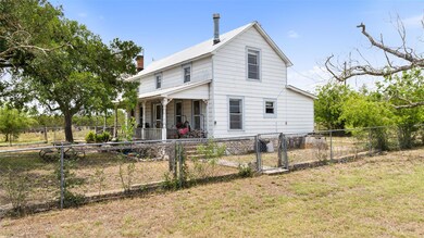 Rear view of house featuring covered porch, a gat
