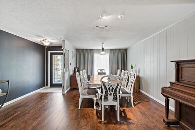 Dining area with a textured ceiling and hardwood /