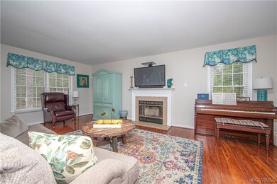 Living room with fireplace and hardwood flooring