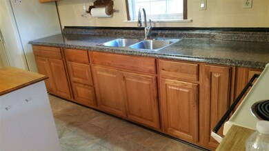 new stainless steel double bowl sink, new counter top and oak cabinets