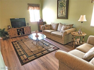 Den with hardwood / wood-style flooring