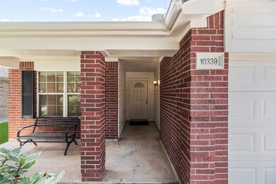 Welcoming covered front porch with brick columns,