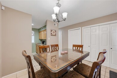Dining room featuring light tile patterned floorin