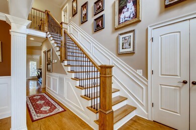 Two story entry foyer. Staircase with wrought iron banister & wood steps.  Plenty of closets in home for extra storage.  Notice the amazing trim throughout the home; STUNNING!  Beautiful hardwood floors on main living area & hallway upstairs.