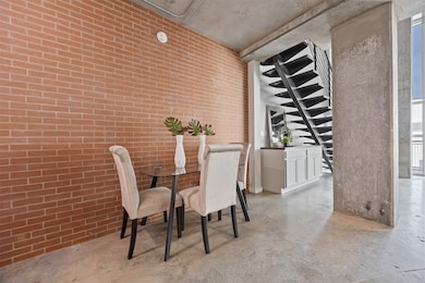 Set against an exposed brick accent wall, the dini