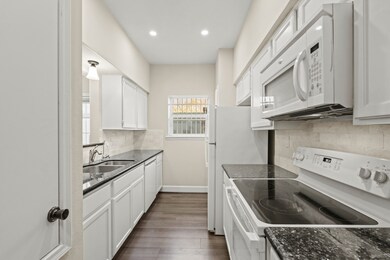 GRANITE COUNTERS, FLAT SURFACE FLOORING AND A TON