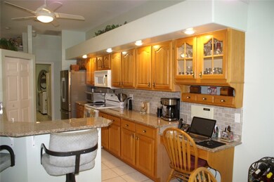 Kitchen with breakfast bar. Note desk area on righ