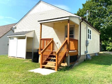 Back of home with deck and covered walk-out