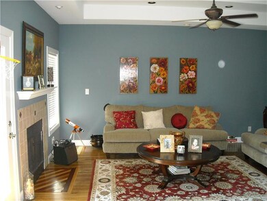 Living room offers lots of light and fireplace