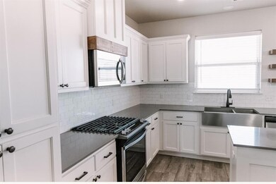 Kitchen featuring plenty of natural light, white c