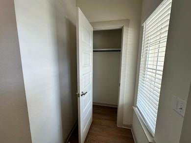Corridor with wood finished floors and healthy am