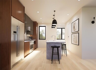 Kitchen with modern cabinets, stainless steel appliances, light wood-type flooring, a breakfast bar, and an island with sink