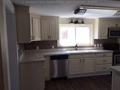 VIEW OF THE KITCHEN FROM THE DINING ROOM. NEW STAI