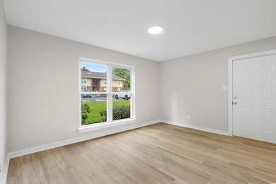 Spare room featuring light wood-style flooring and