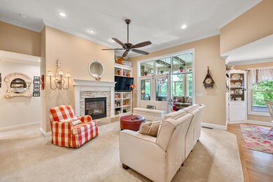 The Great Room offers 12 ft ceilings, a charming fireplace & built-in shelving.