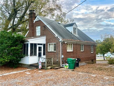 Rear view of property with a sunroom