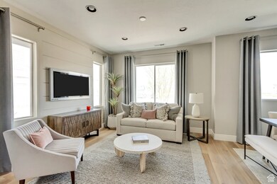 PHOTOS FOM SIMILAR MODEL HOME. FINISHES, COLORS, AND OPTIONS WILL VARY. Living area featuring light wood-style floors and recessed lighting