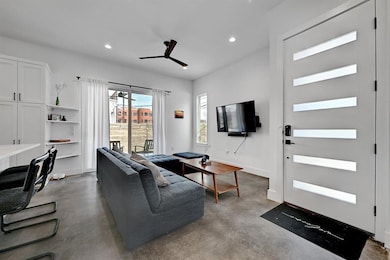 Living area featuring a ceiling fan, recessed lig