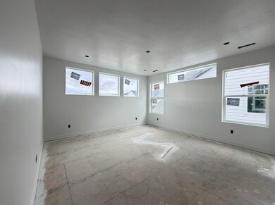 Unfurnished room with baseboards and a textured ceiling
