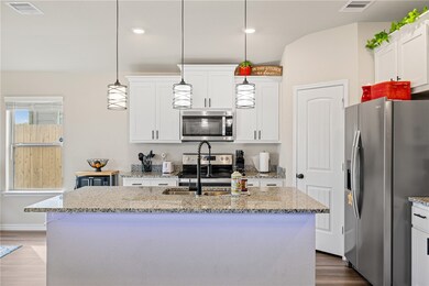 Kitchen featuring stainless steel appliances, a si