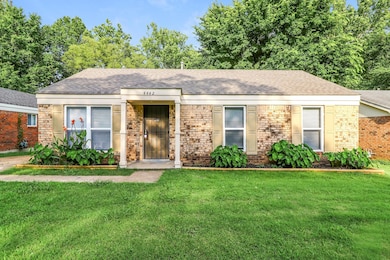 Single story home with a front yard, roof with shingles, and brick siding