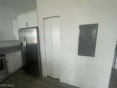 Kitchen with electric range oven, dark wood-style
