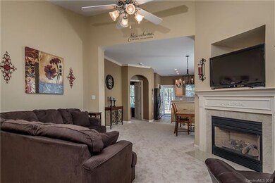Open concept great room with gas fireplace.
