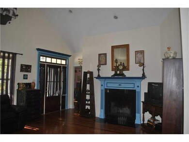 Living Room. Front  door and wood burning fireplac