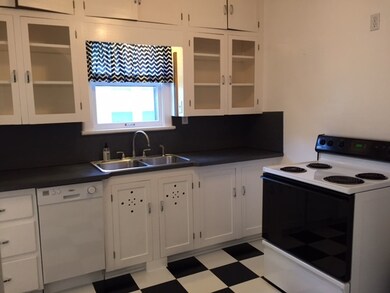 Notice the original cabinets complete with glass d