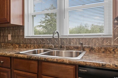 Kitchen with sink, dishwashing machine, and tastef