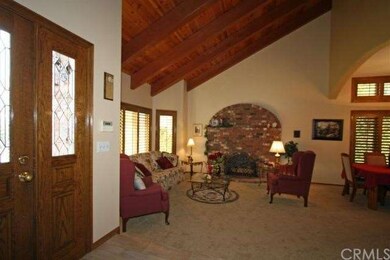 Formal living room with lovely brick fireplace. 