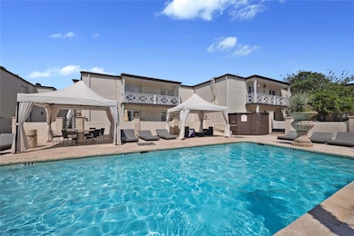 Community pool featuring a patio, a gazebo, and fe