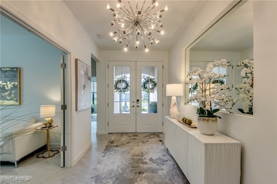 Foyer entrance with a notable chandelier, french d