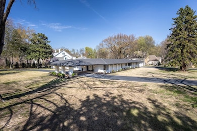 Single story home featuring a carport and driveway