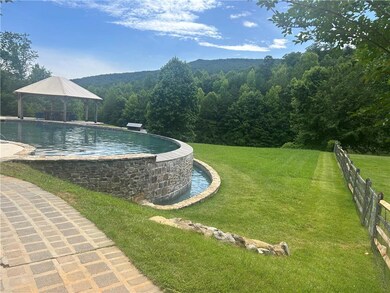 View of community with a gazebo, a lawn, and a swi