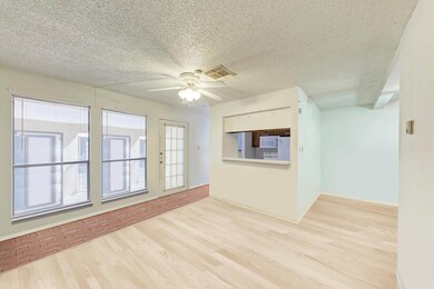 Unfurnished living room featuring ceiling fan, li