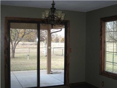 Dining area sliding glass door leading to covered 