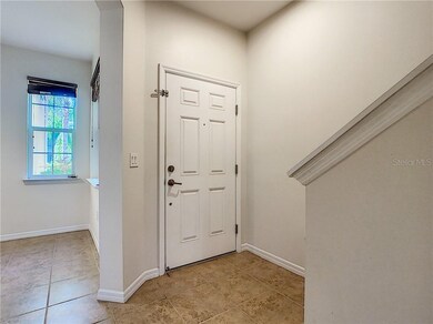Entry and foyer to kitchen and caf table by window