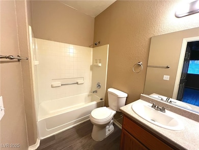 Full bath featuring wood finished floors, toilet,