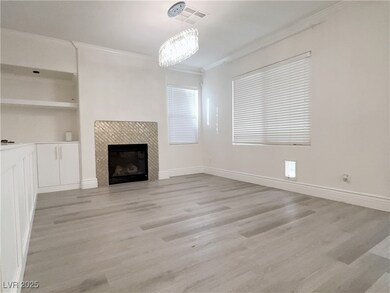 Unfurnished living room featuring baseboards, visi