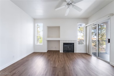 Unfurnished living room featuring wood finished fl