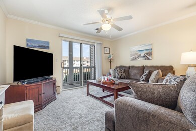 Living room featuring ceiling fan, ornamental mold