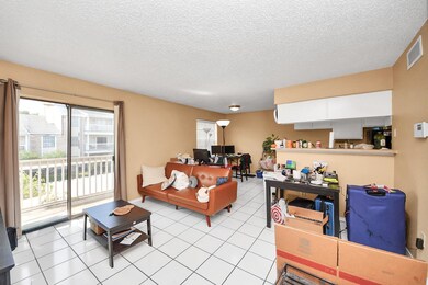 This bright living space features white tile floor
