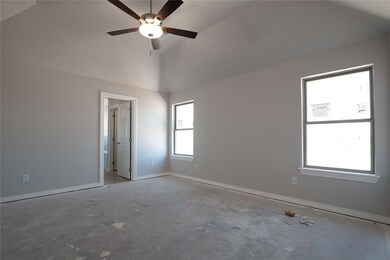 Empty room with high vaulted ceiling, concrete flo